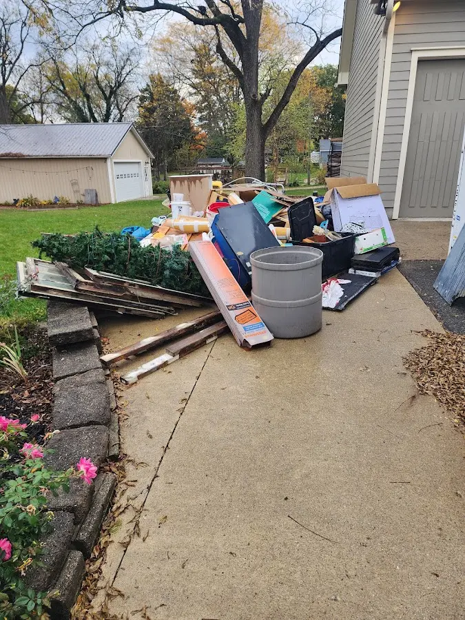 Dumpster being loaded with debris for Residential Dumpster Rental in Pinellas Park